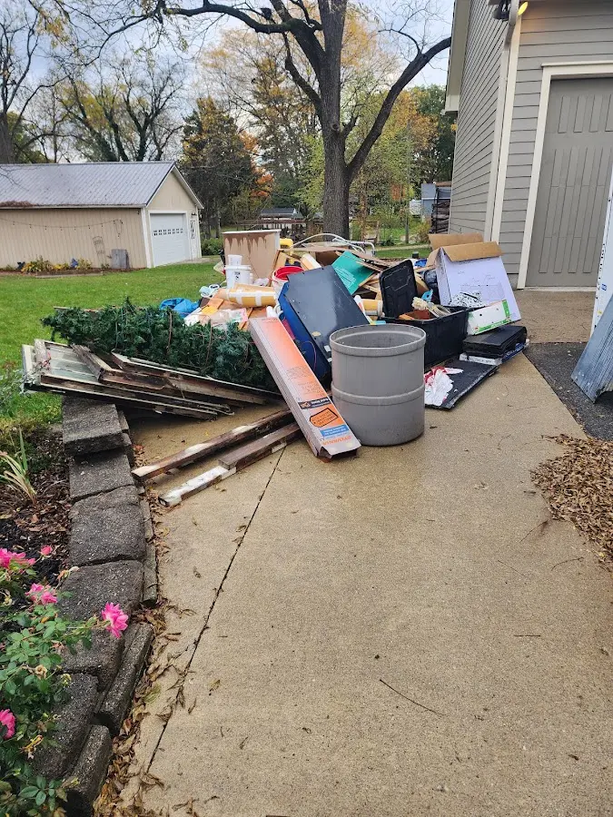 Dumpster being loaded with debris for Estate Cleanout Dumpster Rental in Marble Falls